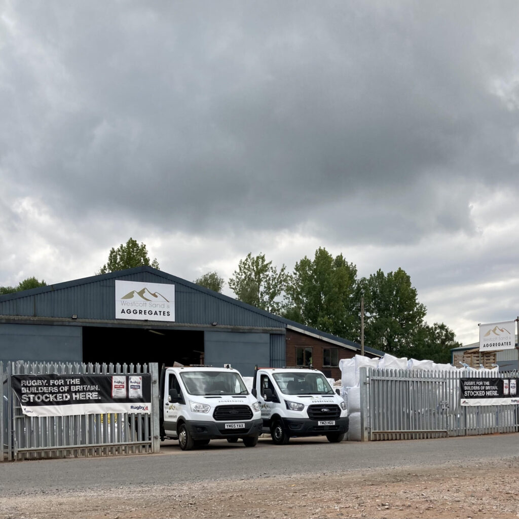 The Westcott Sands & Aggregates yard and warehouse with 2 trucks displayed at the entrance
