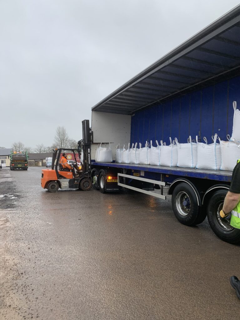 packing lorry being loaded with dumpy bags